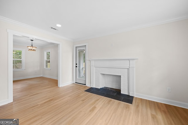 1905 Azalea, Valdosta, GA 31602 - unfurnished living room with a chandelier, light wood-style floors, baseboards, ornamental molding, and a fireplace