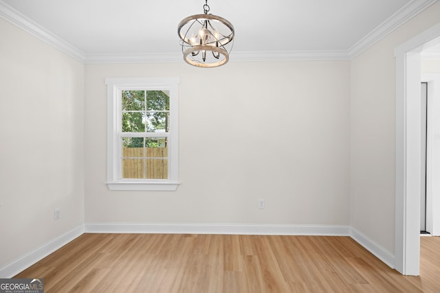 1905 Azalea, Valdosta, GA 31602 - spare room featuring a chandelier, light wood-type flooring, crown molding, and baseboards