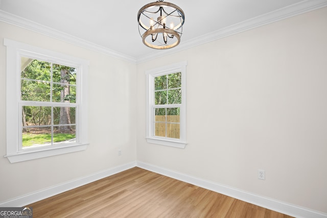 1905 Azalea, Valdosta, GA 31602 - empty room with baseboards, a chandelier, plenty of natural light, light wood-style floors, and crown molding