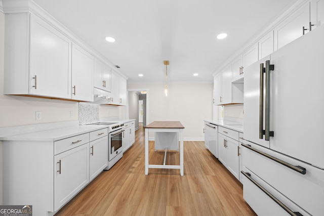 1905 Azalea, Valdosta, GA 31602 - kitchen with high end appliances, white cabinets, light wood-style flooring, tasteful backsplash, and recessed lighting
