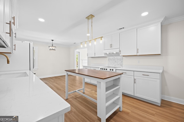 1905 Azalea, Valdosta, GA 31602 - kitchen with a sink, ornamental molding, decorative backsplash, baseboards, and white cabinetry