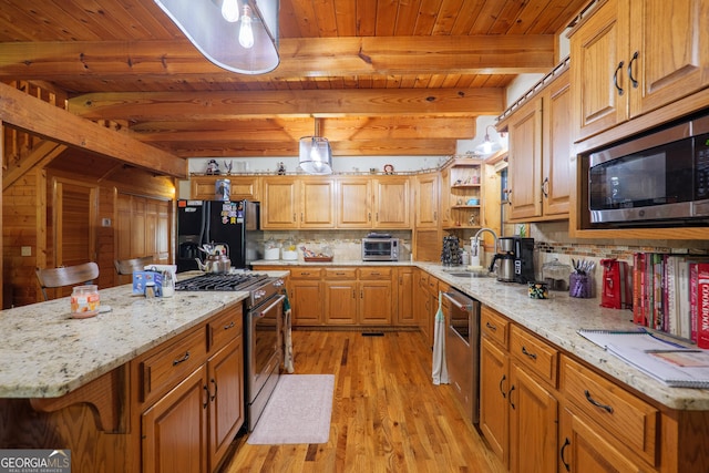 3382 Antioch Greggs Rd, Adel, GA 31620 - kitchen with appliances with stainless steel finishes, a sink, light wood-style flooring, wooden ceiling with exposed beams, and tasteful backsplash