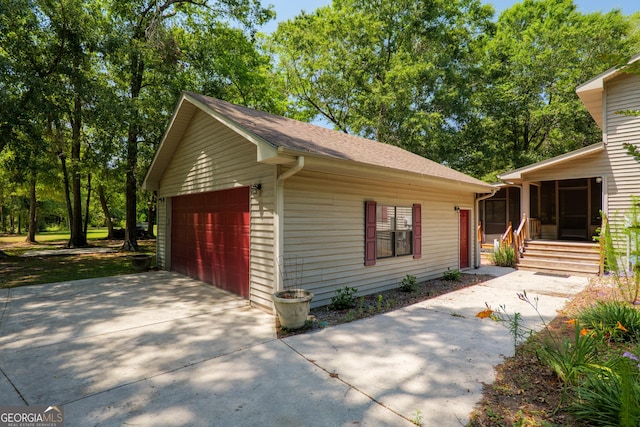 3382 Antioch Greggs Rd, Adel, GA 31620 - view of front of home with a sunroom, a garage, and a shingled roof