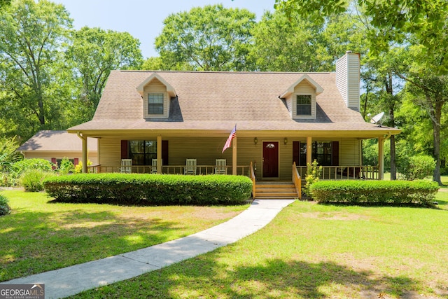 3382 Antioch Greggs Rd, Adel, GA 31620 - view of front facade with covered porch, a chimney, and a front yard