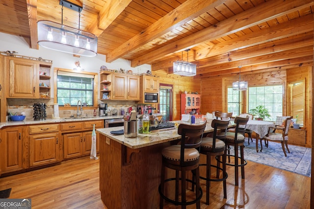 3382 Antioch Greggs Rd, Adel, GA 31620 - kitchen featuring stainless steel microwave, open shelves, light wood-style floors, wood ceiling with exposed beams, and a sink