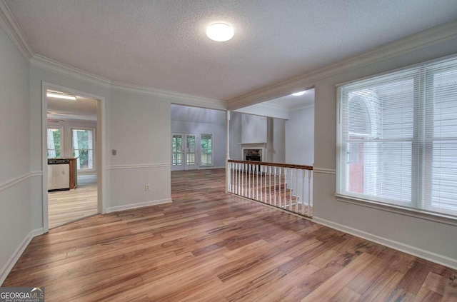 23 Timberlake Pointe NE, Cartersville, GA 30121 - unfurnished room featuring wood finished floors, a textured ceiling, plenty of natural light, crown molding, and baseboards