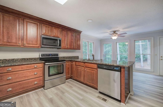 23 Timberlake Pointe NE, Cartersville, GA 30121 - kitchen with stainless steel appliances, a sink, brown cabinets, ornamental molding, and a peninsula