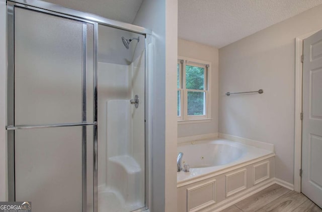 23 Timberlake Pointe NE, Cartersville, GA 30121 - full bath with a shower stall, a jetted tub, a textured ceiling, and wood finished floors