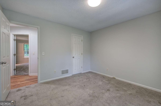 23 Timberlake Pointe NE, Cartersville, GA 30121 - unfurnished bedroom featuring carpet flooring, baseboards, and a textured ceiling