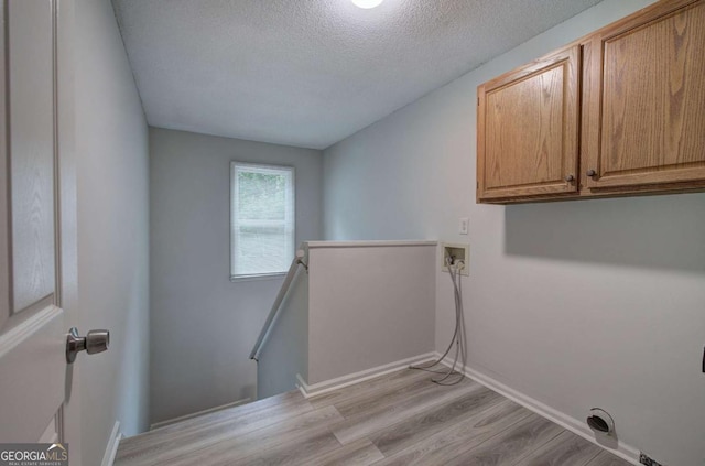 23 Timberlake Pointe NE, Cartersville, GA 30121 - laundry room featuring cabinet space, hookup for a washing machine, light wood-type flooring, a textured ceiling, and baseboards