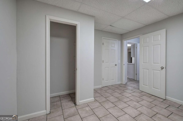 23 Timberlake Pointe NE, Cartersville, GA 30121 - unfurnished bedroom with a paneled ceiling, light tile patterned floors, a closet, and baseboards