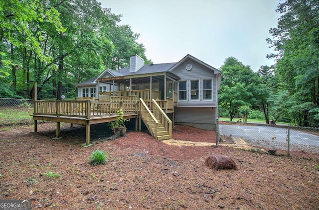 23 Timberlake Pointe NE, Cartersville, GA 30121 - back of property featuring a sunroom, a wooden deck, a chimney, and stairway