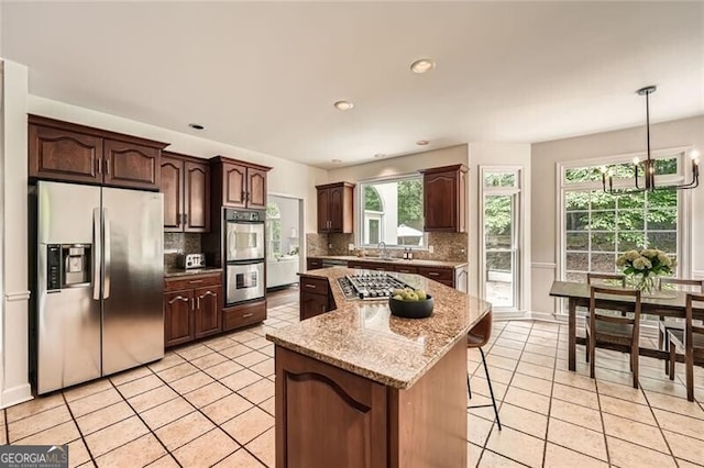 5940 Plantation Dr, Roswell, GA 30075 - kitchen featuring appliances with stainless steel finishes, backsplash, a center island, a sink, and recessed lighting