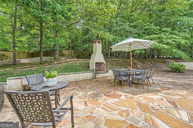 5940 Plantation Dr, Roswell, GA 30075 - fenced backyard featuring outdoor dining space, a patio area, and an outdoor fireplace