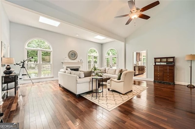 5940 Plantation Dr, Roswell, GA 30075 - living area featuring plenty of natural light, wood-type flooring, a fireplace, and high vaulted ceiling