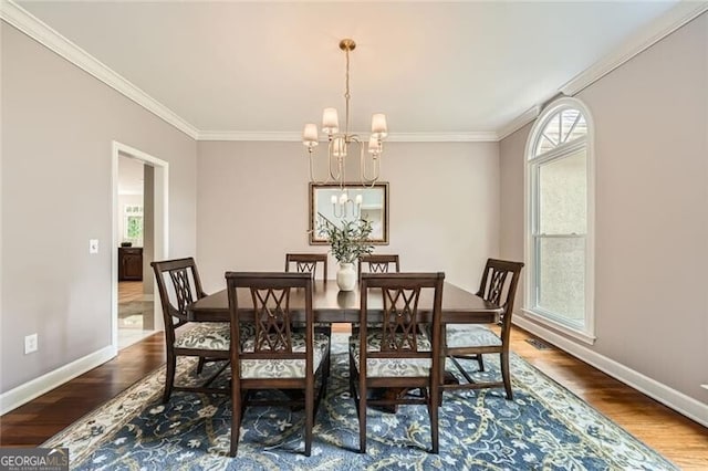 5940 Plantation Dr, Roswell, GA 30075 - dining space featuring a chandelier, wood finished floors, ornamental molding, and baseboards