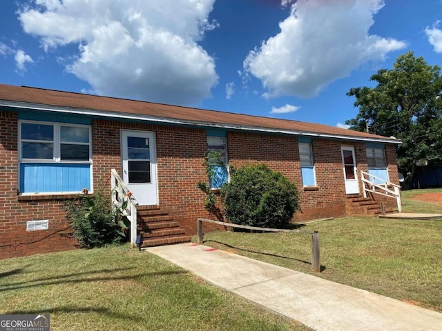245 Horton Dr, Americus, GA 31719 - ranch-style house featuring entry steps, brick siding, and a front yard