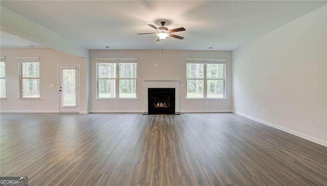 165 Cooper Cv E, Fayetteville, GA 30215 - unfurnished living room featuring a ceiling fan, healthy amount of natural light, baseboards, and dark wood finished floors