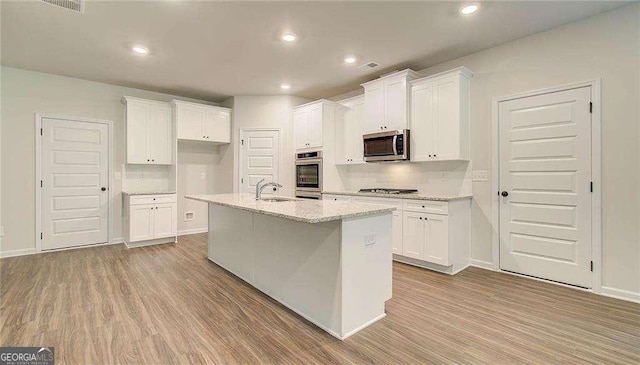 165 Cooper Cv E, Fayetteville, GA 30215 - kitchen featuring stainless steel appliances, a sink, white cabinets, wood finished floors, and recessed lighting