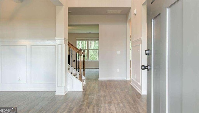 165 Cooper Cv E, Fayetteville, GA 30215 - foyer entrance featuring a decorative wall, wood finished floors, stairway, wainscoting, and baseboards