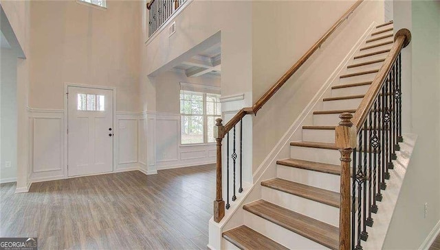 165 Cooper Cv E, Fayetteville, GA 30215 - foyer with a decorative wall, wood finished floors, stairs, wainscoting, and a towering ceiling