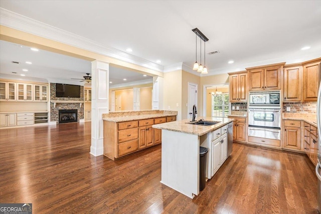 737 Raleigh Cobb Rd, Hawkinsville, GA 31036 - kitchen with appliances with stainless steel finishes, a warming drawer, a sink, a ceiling fan, and a fireplace