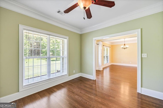 737 Raleigh Cobb Rd, Hawkinsville, GA 31036 - empty room with a chandelier, plenty of natural light, crown molding, dark wood-style flooring, and baseboards