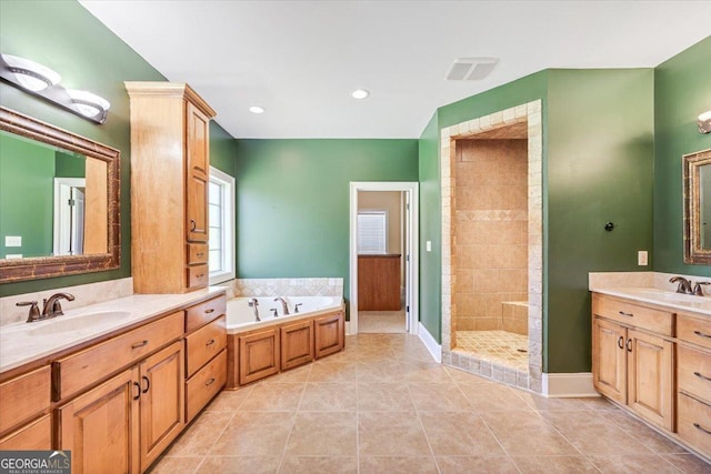 737 Raleigh Cobb Rd, Hawkinsville, GA 31036 - full bathroom with a shower stall, a bath, two vanities, tile patterned flooring, and baseboards