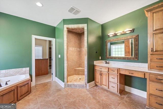 737 Raleigh Cobb Rd, Hawkinsville, GA 31036 - bathroom with a tile shower, a bath, vanity, baseboards, and tile patterned floors