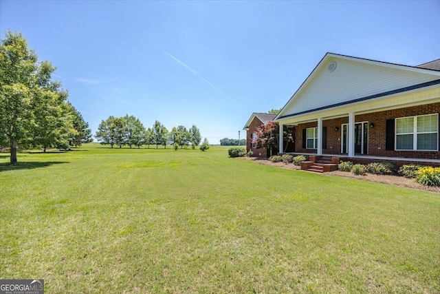 737 Raleigh Cobb Rd, Hawkinsville, GA 31036 - view of grassy yard with a porch