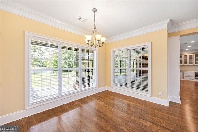 737 Raleigh Cobb Rd, Hawkinsville, GA 31036 - unfurnished dining area with a chandelier, crown molding, wood finished floors, and baseboards