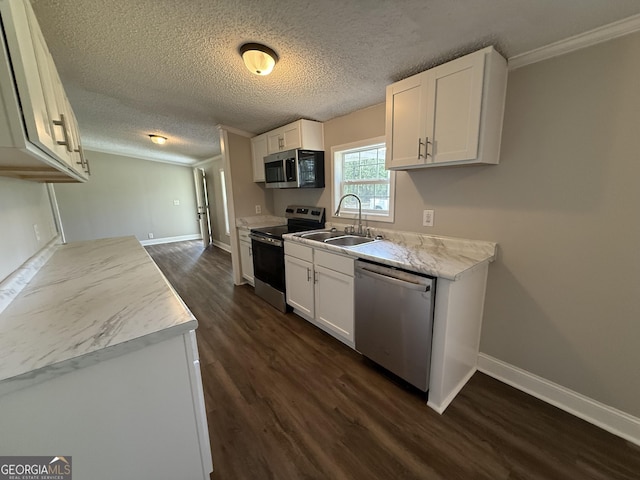 12103 US Highway 80 E, Brooklet, GA 30415 - kitchen featuring appliances with stainless steel finishes, a sink, dark wood-style flooring, white cabinets, and light countertops