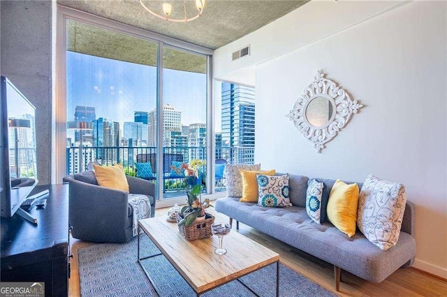 860 Peachtree St NE Unit 1613, Atlanta, GA 30308 - living area with a wall of windows, plenty of natural light, wood finished floors, and a view of city