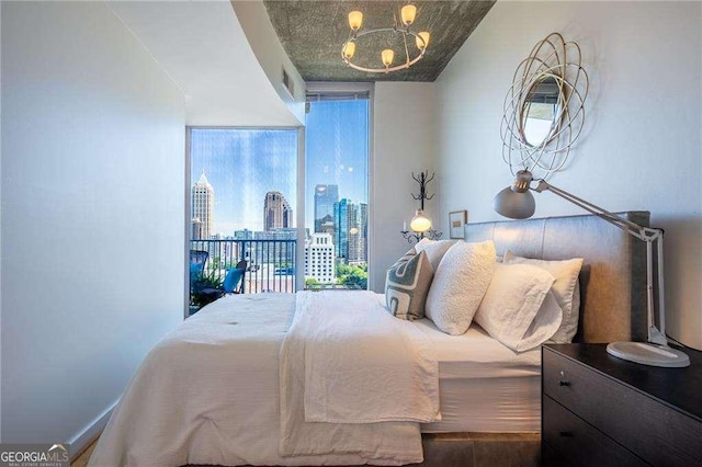 860 Peachtree St NE Unit 1613, Atlanta, GA 30308 - bedroom with floor to ceiling windows, a chandelier, and a view of skyline