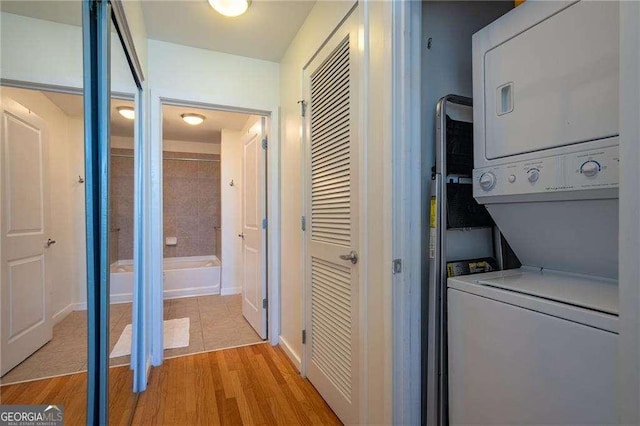 860 Peachtree St NE Unit 1613, Atlanta, GA 30308 - washroom featuring stacked washer and clothes dryer and light wood-style floors