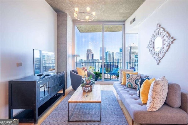 860 Peachtree St NE Unit 1613, Atlanta, GA 30308 - living area featuring floor to ceiling windows, a chandelier, plenty of natural light, and wood finished floors