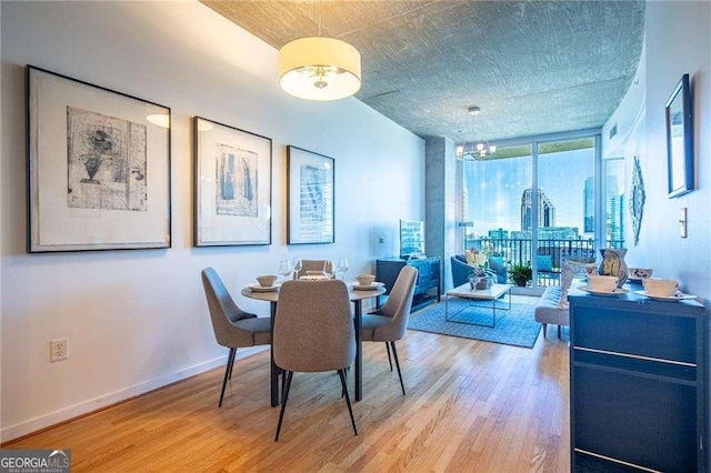 860 Peachtree St NE Unit 1613, Atlanta, GA 30308 - dining space with light wood-type flooring, a wall of windows, and a chandelier