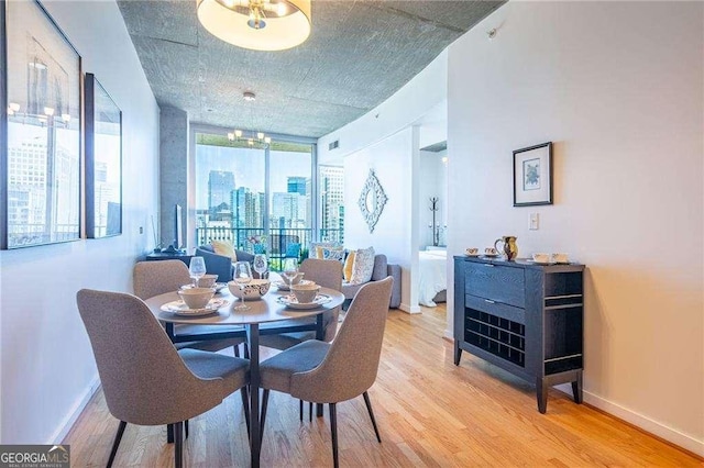 860 Peachtree St NE Unit 1613, Atlanta, GA 30308 - dining area featuring light wood finished floors and a city view