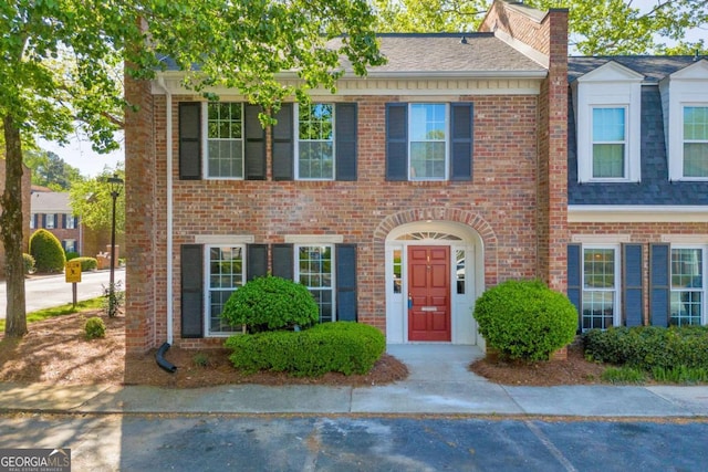 1 N Boundary Pl NW, Atlanta, GA 30318 - view of property featuring brick siding, a shingled roof, and a chimney