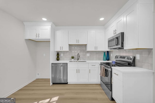 1 N Boundary Pl NW, Atlanta, GA 30318 - kitchen with stainless steel appliances, a sink, white cabinetry, light countertops, and tasteful backsplash