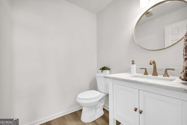 1 N Boundary Pl NW, Atlanta, GA 30318 - bathroom featuring vanity, wood finished floors, toilet, and baseboards