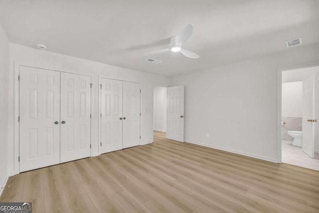 1 N Boundary Pl NW, Atlanta, GA 30318 - unfurnished bedroom featuring two closets, light wood-type flooring, baseboards, ensuite bath, and a ceiling fan