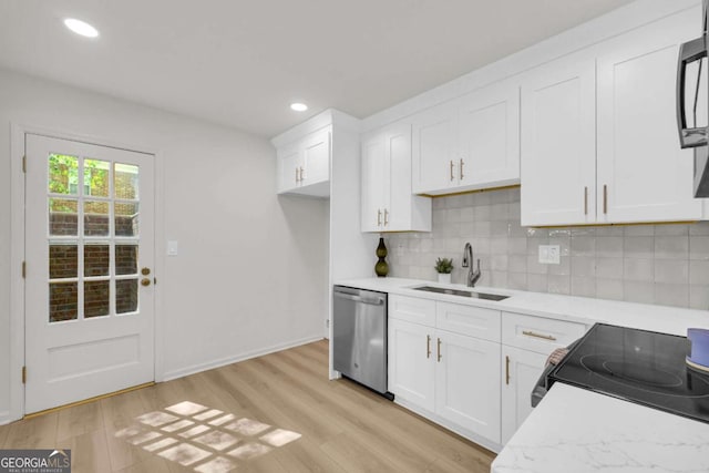 1 N Boundary Pl NW, Atlanta, GA 30318 - kitchen with stainless steel dishwasher, a sink, backsplash, light wood finished floors, and white cabinets