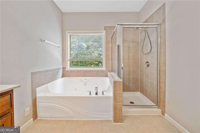 100 Trailside Way, Hiram, GA 30141 - bathroom with a tub with jets, a stall shower, vanity, and tile patterned floors