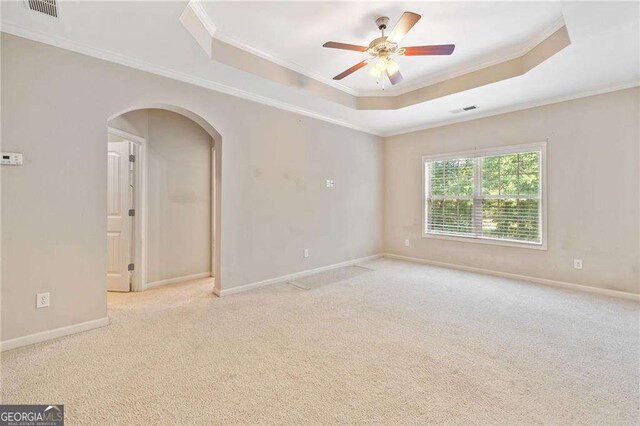 100 Trailside Way, Hiram, GA 30141 - unfurnished room featuring a raised ceiling, arched walkways, crown molding, a ceiling fan, and carpet floors