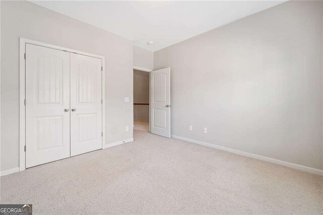 100 Trailside Way, Hiram, GA 30141 - unfurnished bedroom featuring carpet flooring, baseboards, and a closet