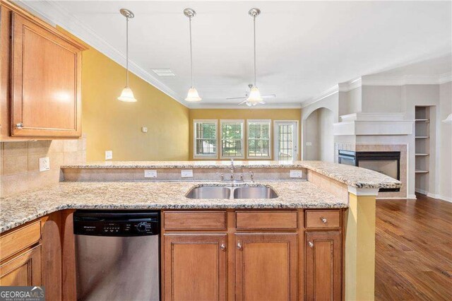 100 Trailside Way, Hiram, GA 30141 - kitchen featuring stainless steel dishwasher, a sink, brown cabinetry, a ceiling fan, and a tiled fireplace