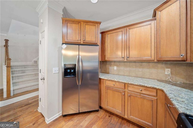 100 Trailside Way, Hiram, GA 30141 - kitchen featuring stainless steel refrigerator with ice dispenser, crown molding, light wood finished floors, brown cabinets, and tasteful backsplash