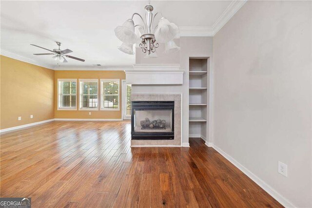 100 Trailside Way, Hiram, GA 30141 - unfurnished living room featuring ornamental molding, hardwood / wood-style flooring, a tile fireplace, and baseboards