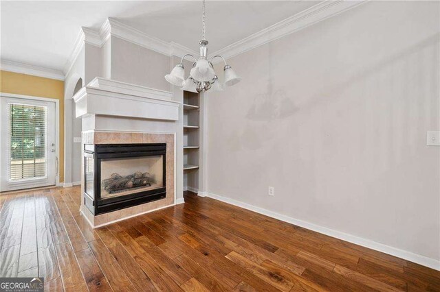 100 Trailside Way, Hiram, GA 30141 - unfurnished living room with a chandelier, hardwood / wood-style flooring, crown molding, baseboards, and a multi sided fireplace